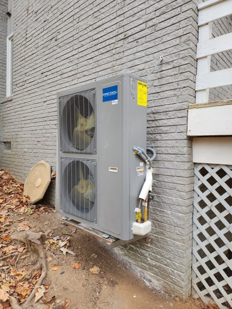 A wall-mounted MRCOOL multi-zone outdoor HVAC unit installed on a brick wall by Sizemore Heating & Air, LLC in Chapel Hill, NC