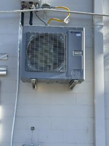 A wall-mounted outdoor HVAC unit installed on a commercial building by Wicked Cool HVAC in Charleston, SC.