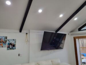 Wall-mounted television and recessed lighting installed in a living space by Minards Electric LLC in Dickinson, ND.