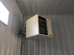 A wall-mounted unit heater installed in a garage or workshop by Butte Heating & Cooling in Rapid City, SD.