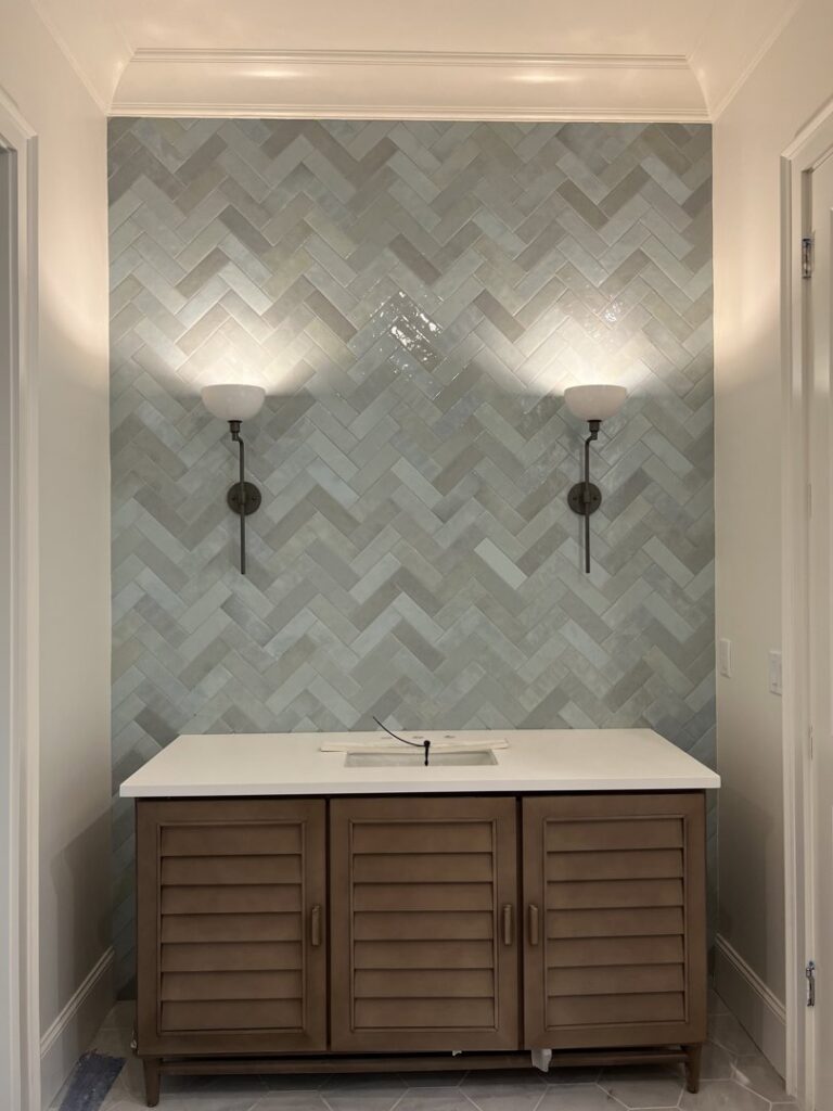 New wall sconce lighting installation above a bathroom vanity by OceanSide Electric in Hilton Head Island, SC.
