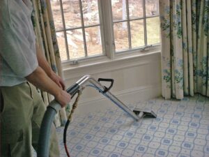 A professional performing wall-to-wall carpet cleaning service in a home by Ziegler Preservation Cleaning in Danbury, CT