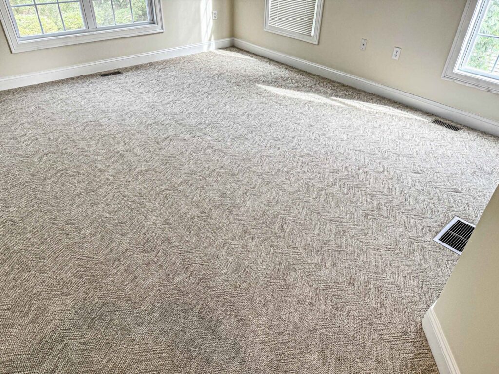A newly installed wall-to-wall carpet in a spacious room by Kaoud Rugs in West Hartford, CT.