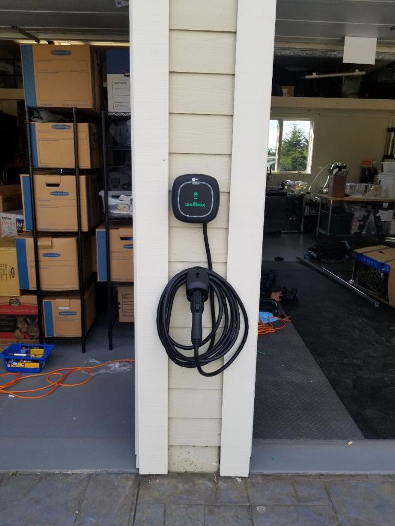 A Wallbox electric vehicle charger installed on a pillar in a garage by Wisdom Electrical in San Francisco, CA.