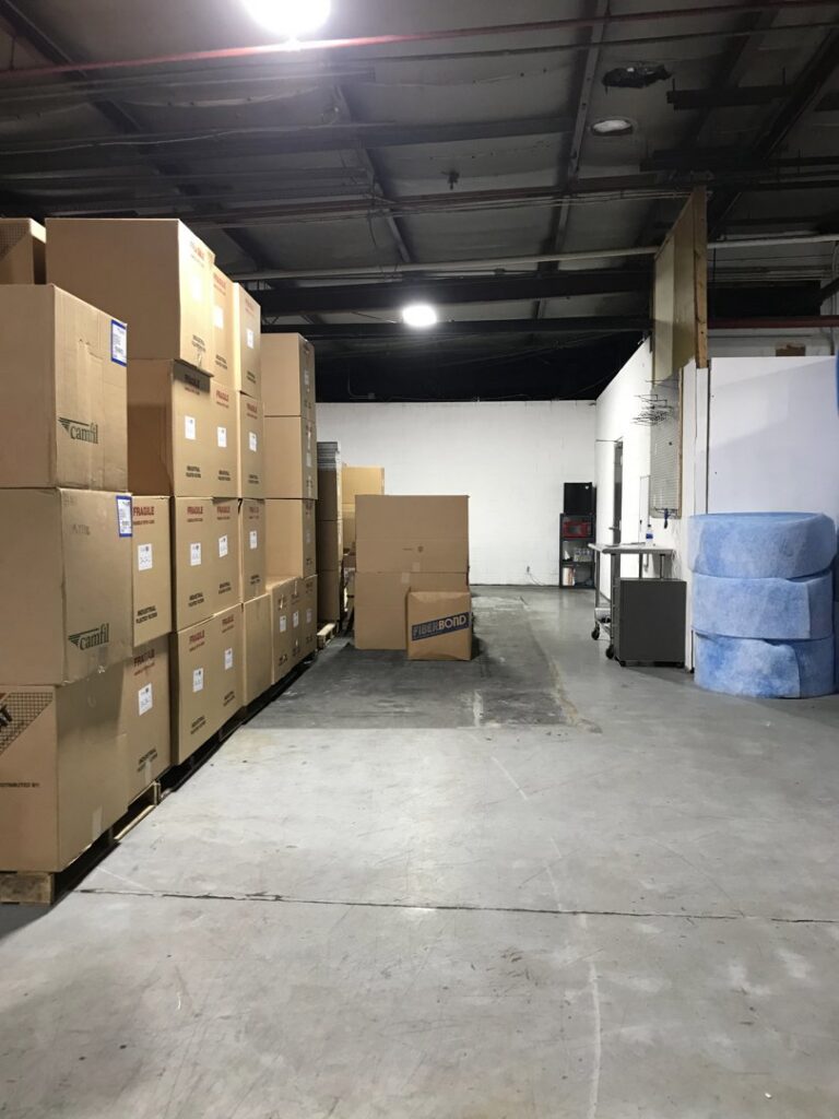 Interior view of the Murray Filter Sales and Service, Inc. warehouse showing boxes and blue filter media inventory in Nashville, TN