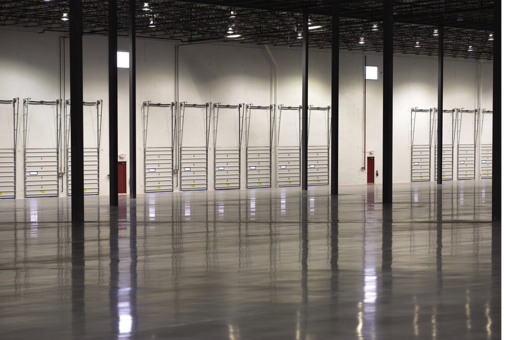 The interior of a large warehouse with multiple loading dock doors installed by Fort Wayne Door & Dock, Inc. in Fort Wayne, IN