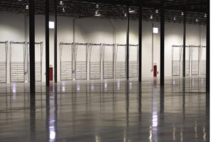 The interior of a large warehouse with multiple loading dock doors installed by Fort Wayne Door & Dock, Inc. in Fort Wayne, IN