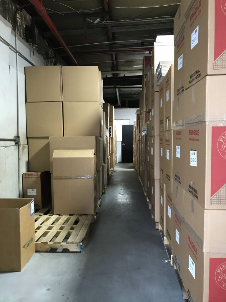 Warehouse aisle with stacked inventory boxes at Murray Filter Sales and Service, Inc. in Nashville, TN