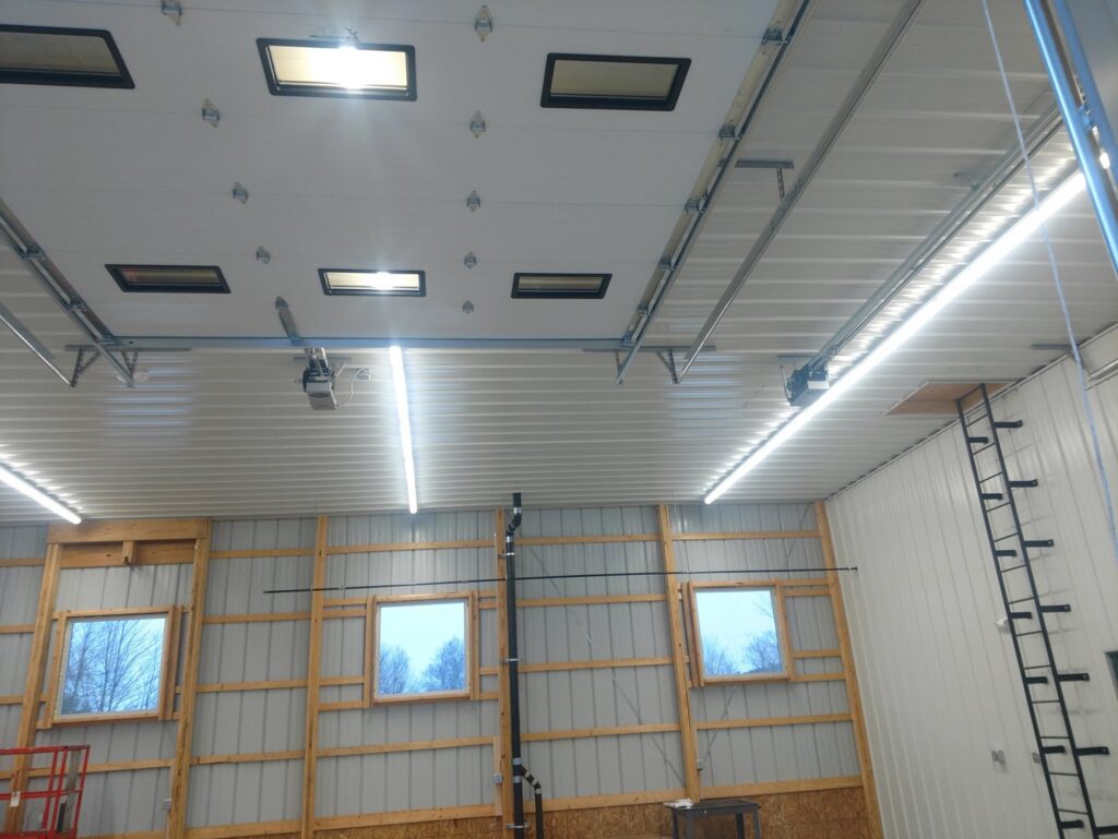 Overhead LED lighting and garage door openers installed in a warehouse by Icon West Corporation Electrical Contractors in Springfield, MA.