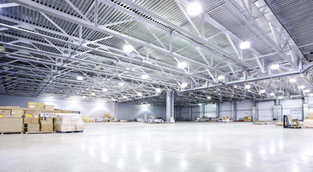 A spacious warehouse interior showcasing a professional LED lighting installation by Lighting Services, Inc. in Waterbury, CT.