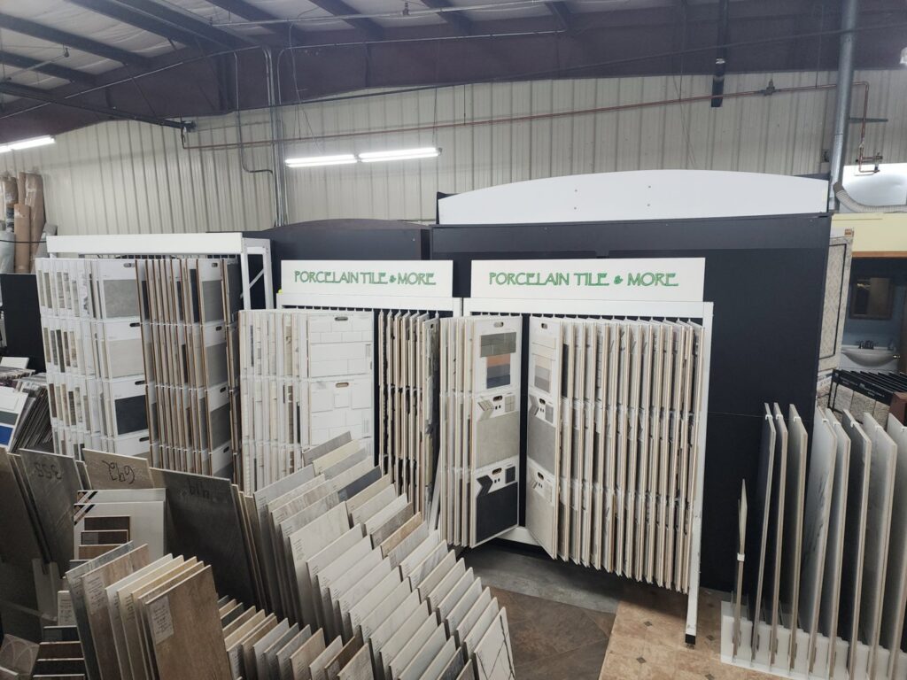 A warehouse section displaying various tile flooring inventory at CarpetsPlus Colortile in Swansea, MA