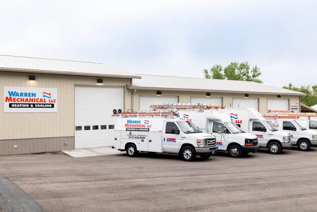 The Warren Mechanical, LLC business building with a fleet of service vans parked outside in Carmel, IN.