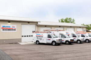 The Warren Mechanical, LLC business building with a fleet of service vans parked outside in Carmel, IN.