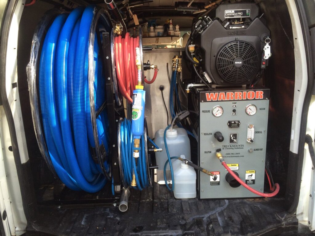 A Warrior truckmount carpet cleaning system with hoses inside a Dirt Blasters Carpet Cleaning Inc. van in Atlanta, GA
