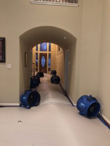 Water damage drying equipment set up in a home hallway by Xtreme Clean Restoration & Carpet Care in San Antonio, TX