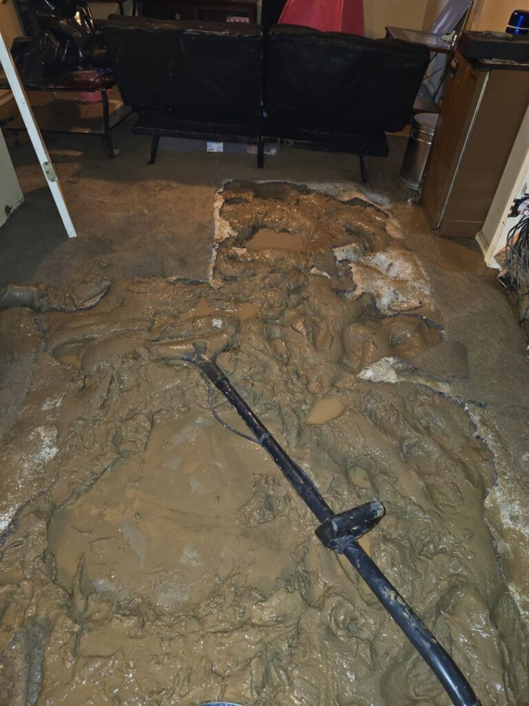 Water damage restoration work on a muddy floor, a service provided by Big Red Flooring in Omaha, NE