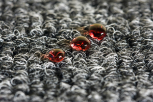 Close-up of water droplets on a dark carpet, showcasing water protection by Xtreme Clean Restoration & Carpet Care in San Antonio, TX