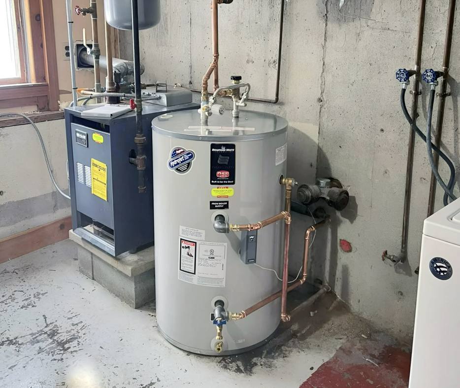 A new water heater and furnace installed in a basement by Precision Heating and Gas Service in Derry, NH