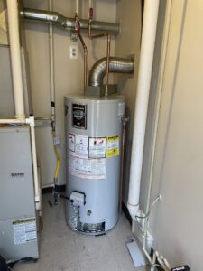 A newly installed water heater and furnace unit in a utility closet, serviced by SANKS Mechanical in Philadelphia, PA.