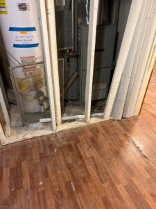 A water heater and furnace unit installed behind framing by Spartan Mechanical KC in Spring Hill, KS.