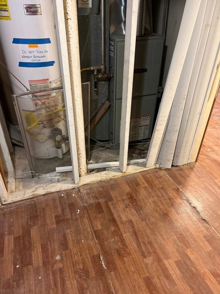 A water heater and furnace unit installed behind framing by Spartan Mechanical KC in Spring Hill, KS.