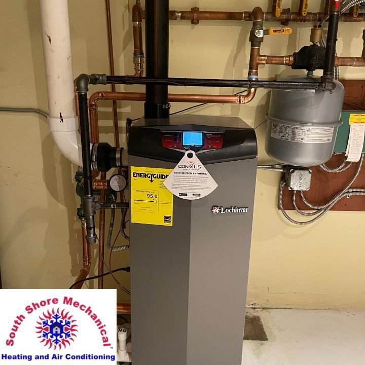 A modern water heater or boiler unit with copper piping installed by South Shore Mechanical in Abington, MA