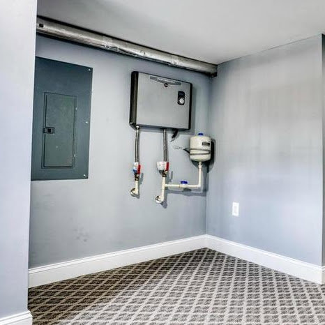 A water heater or boiler system installed in a utility space, maintained by Simply Home Service in Gaithersburg, MD.