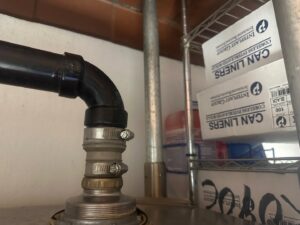 Close-up of a water heater control panel and plumbing connections by McCutcheon & Sons Air Conditioning and Plumbing in Tempe, AZ