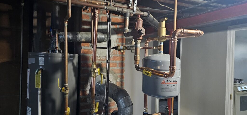 A water heater and expansion tank with new copper piping installed by Allied Heating and Air Conditioning in Port Richey, FL.