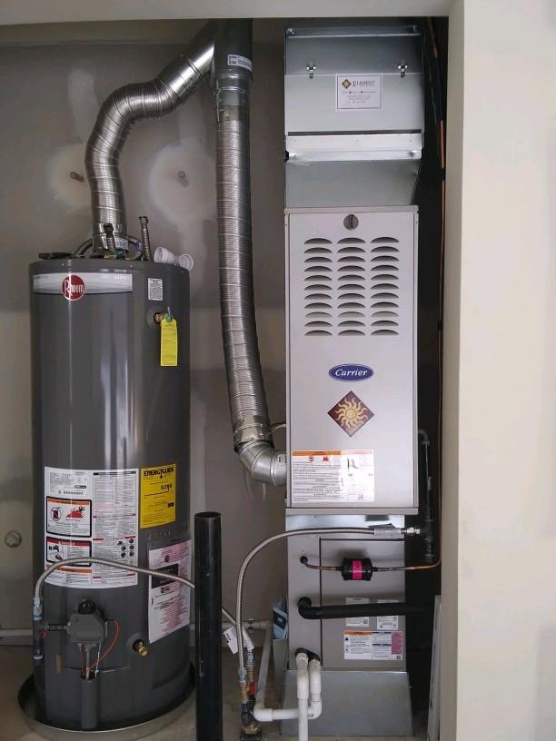 A newly installed water heater and furnace unit in a utility closet by Element Heating & Cooling, Inc. in Twin Falls, ID
