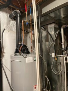 A water heater and furnace installation in a utility area by National Heating & Cooling Company in Lakewood, CO.