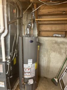 A water heater and furnace unit in a utility room, representing services by Spartan Heating, Cooling and Fireplaces in Cedar Rapids, IA