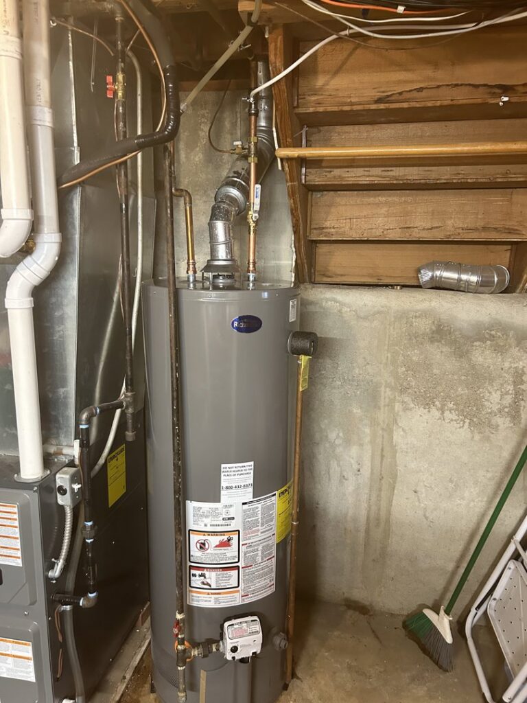 A water heater and furnace unit in a utility room, representing services by Spartan Heating, Cooling and Fireplaces in Cedar Rapids, IA