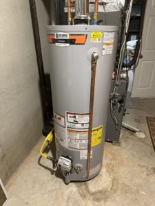 A new water heater installed in a utility room by A.B. May Heating, A/C, Plumbing & Electrical in Kansas City, MO.