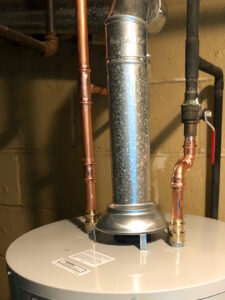 A water heater with new copper piping and a galvanized exhaust flue installed by Ohio City Heating and Cooling in Cleveland, OH.