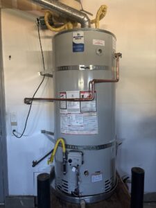 A new water heater installation with visible plumbing and venting by DeHart Plumbing, Heating, & Air in Sparks, NV