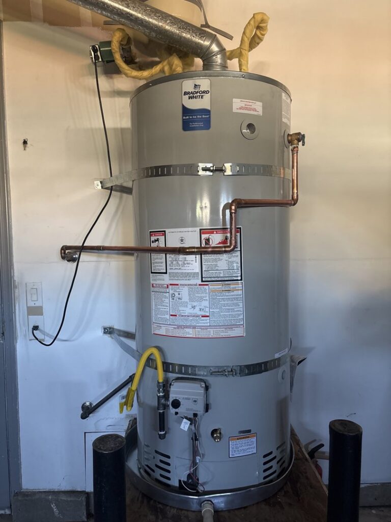 A new water heater installation with visible plumbing and venting by DeHart Plumbing, Heating, & Air in Sparks, NV