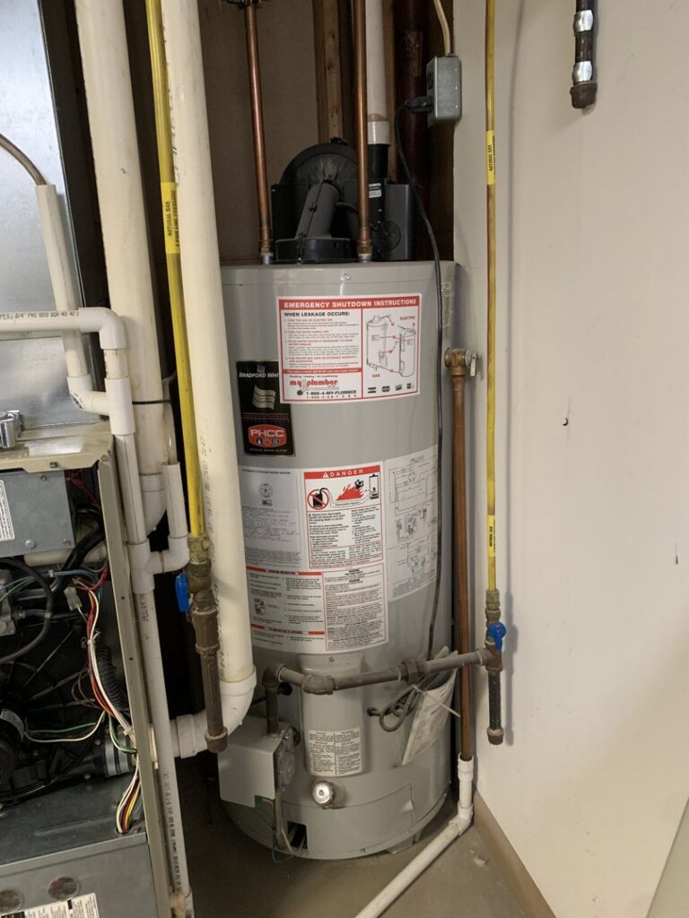 A water heater installation with associated piping, part of the services offered by AVS Heating and Air Conditioning in Alexandria, VA.