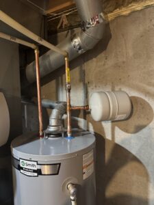 A new water heater installation with copper piping and ductwork in a basement by Lopez Mechanical HVAC in Kansas City, MO.
