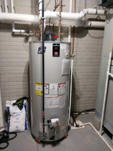 A newly installed water heater in a utility room by Raymond Plumbing, Heating & Air Conditioning in Lorain, OH.