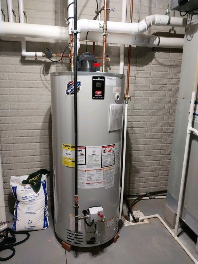 A newly installed water heater in a utility room by Raymond Plumbing, Heating & Air Conditioning in Lorain, OH.