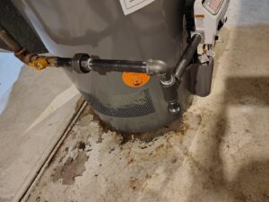 A close-up of a water heater installation or repair with associated piping by Thrasher Service Corp in Des Moines, IA.