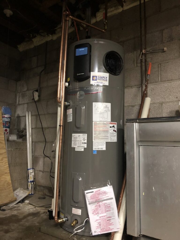 A newly installed water heater with a Simply Installs Heating & Air Conditioning sticker, located in Shortsville, NY.