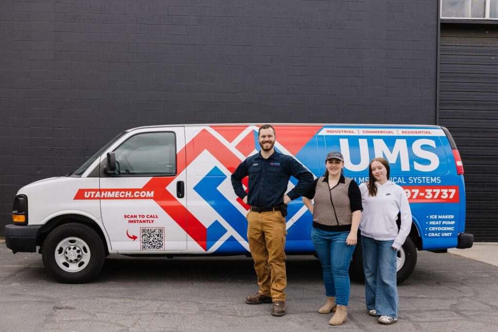 Two water heaters installed in a utility room by Utah Mechanical Systems in South Ogden, UT.
