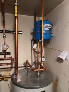 A new water heater installation with intricate copper piping by True Heating and Cooling in Greenfield, IN.