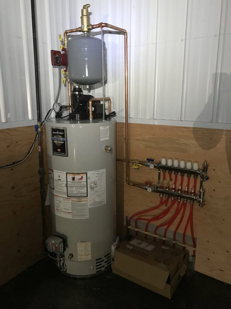 A water heater connected to a radiant heating manifold system, installed by Simply Installs Heating & Air Conditioning in Shortsville, NY.