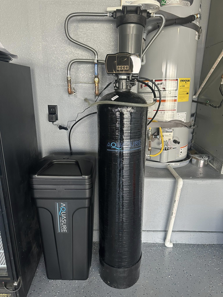 Professional installation of an A.O. Smith water heater and Aquasure water softener system by CaliFam Services in Las Vegas, NV.