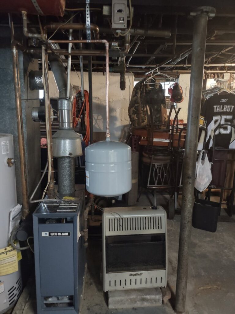 A Weil-McLain boiler and heating system with an expansion tank, installed or serviced by Delgado Enterprises in Pittsburgh, PA