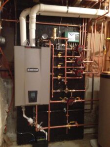 A Weil-McLain boiler and complex copper piping system installed by C & C Temp Control in Worcester, MA.