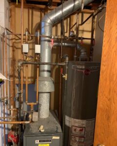 An existing Weil-McLain furnace and Rheem water heater, representing systems serviced by TruTemp Heating & Cooling LLC in Ijamsville, MD.